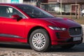 Electric Car on the street, red Jaguar I-PACE close-up. Motion blur. Riga, Latvia - 31 Mar 2022