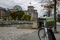 Electric city rental bike over blurred reichstag background, ecological culture