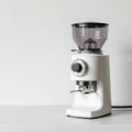Electric coffee grinder with a modern design features a white base and a transparent Royalty Free Stock Photo