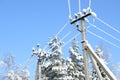 Electric communications wires covered with ice and snow. Snow-covered power cable lines and pole. Power electric transmission line Royalty Free Stock Photo