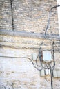 Electric controller box and tangle of cables on brick wall Royalty Free Stock Photo