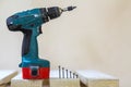 Electric cordless screwdriver and some screws close-up Royalty Free Stock Photo