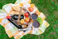 An electric corkscrew lies on a bottle of wine. Near the aerator for wine, two glasses of wine, grapes, fruits and a basket of Royalty Free Stock Photo