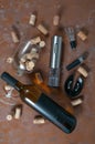 Electric corkscrew metallic gray color. Lies on a brown concrete background. Near a glass, a bottle of wine, corks, aerator, Royalty Free Stock Photo