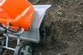 Electric cultivator cultivates soil in vegetable garden Royalty Free Stock Photo