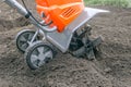 Electric cultivator for cultivating soil in vegetable garden Royalty Free Stock Photo