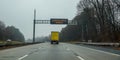 Electric digital warning sign above a truck on a highway that says Coronavirus Ahead.