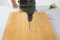 Electric drill drilling a hole