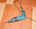 Electric drill, puncher lying on the tile floor Royalty Free Stock Photo