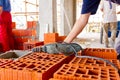 Electric drill tool on pile of red blocks, worker builds wall with bricks and mortar, building site Royalty Free Stock Photo