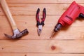 Electric drill, Wooden hammer and pliers Hand tools used on wooden table with copy space Royalty Free Stock Photo