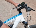 Electric e-bike handle bars and electric controller with mobile phone plugged in to charge form bike battery