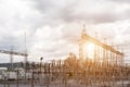 Electric factory power plant and electrical substation on a cloud sky background