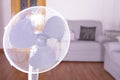 Electric fan that cools the air during a hot day at home