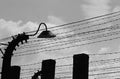 electric fence with barbed wire and an old lamp with bw effect Royalty Free Stock Photo