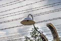 Electric fence with barbed wire and an old lamp Royalty Free Stock Photo