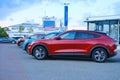 Electric Ford Mustang Mach-E on display in parking lot of company store specializing in sale of electric vehicles, alternative