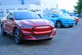 Electric Ford Mustang Mach-E on display in parking lot of company store specializing in sale of electric vehicles, alternative