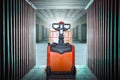 Electric Forklift Pallet Jack with Package Boxes in Cargo Container. Warehouse Shipping. Supply Chain, Shipment, Freight Truck Royalty Free Stock Photo