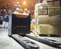 Electric Forklift Pallet Jack with Package Boxes on Pallet at The Storage Warehouse. Shipping Warehouse Logistics Royalty Free Stock Photo