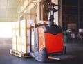 Electric Forklift Pallet Jack with Packaging Boxes on Pallet in The Warehouse. Shipment Boxes. Cargo Supply Chain. Shipping Cargo Royalty Free Stock Photo