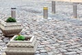 Electric gray hydraulic bollard with a yellow reflective stripe barrier regulating traffic. Royalty Free Stock Photo