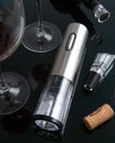 Electric gray metal corkscrew, aerator and vacuum stopper for wine. On a black mirror surface