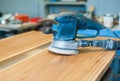 Electric grinder on a board in a carpentry workshop. Close-up Royalty Free Stock Photo
