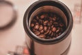 Electric grinder full of coffee beans. The morning drink that wakes you up Royalty Free Stock Photo