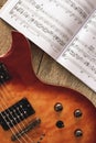 Electric Guitar Chords. Close-up photo of electric guitar body with volume and tone control knobs with music notes Royalty Free Stock Photo