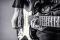 Electric guitar. Close up hand playing guitar. Musician playing guitar, live music. Black and white Royalty Free Stock Photo