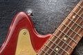 Electric guitar close up shines on slate background