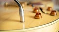 Electric guitar connected plug in cable output jack close up Royalty Free Stock Photo
