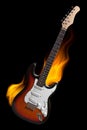 Electric guitar on fire isolated on black