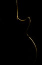 .Electric guitar gold silhouette on a black background