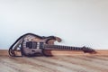 Electric guitar laying on floor in front of white wall Royalty Free Stock Photo