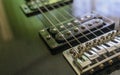 Electric guitar part close-up. Neck and humbucker pickup. Horizontal composition. Studio shot.