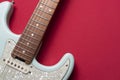 Electric guitar on red table background, close up music concept Royalty Free Stock Photo