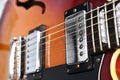 Electric guitar strings close up of bridge and humbucker pickup
