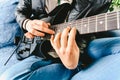 Electric guitar teacher teaching how to place fingers to play a chord