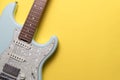 Electric guitar on yellow table background, flat lay, music instrument concept Royalty Free Stock Photo