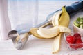 Electric hand blender with stainless steel body with accessories and fruits on wooden background, close up Royalty Free Stock Photo