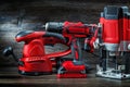 Electric hand tools red wood sanding mashine corded jigsaw cordless drill and small plunge router milling machine portable mini Royalty Free Stock Photo