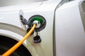 Electric hybrid car plugin in to charger to charging electric power to battery to reserve energy Royalty Free Stock Photo