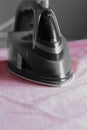 Electric iron on a mans pink shirt Royalty Free Stock Photo