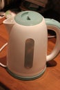 Electric kettle with budy of whire and green plastic Royalty Free Stock Photo