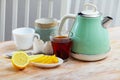 Electric kettle and cup of tea on table Royalty Free Stock Photo