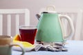 Electric kettle and cup of tea on table Royalty Free Stock Photo