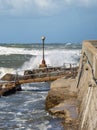 Electric Lamp in the Boardwalk near the Coastline hit by Sea Waves during Storm