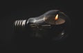Electric lamp and candle on a dark background. Bulb and candle. Power cut or power outa Royalty Free Stock Photo